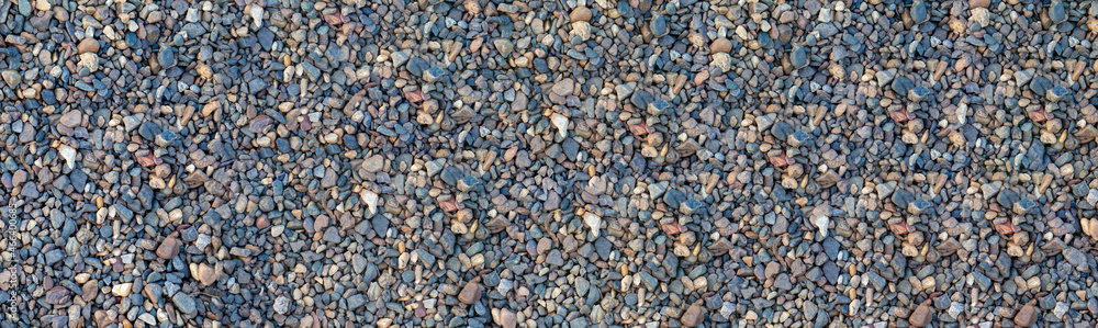 Crushed stone on the seashore. Selective focus on object. The stones were laid on the ground in the garden as a background. Background blur. Pebble stones background. banner Crushed stone on the seashore. Selective focus on object. The stones were laid on the ground in the garden as a background. Background blur. Pebble stones background. banner