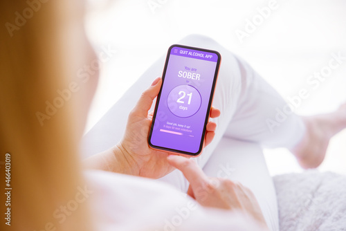 Obraz na plátně Woman using mobile app to track alcohol consumption and quit drinking