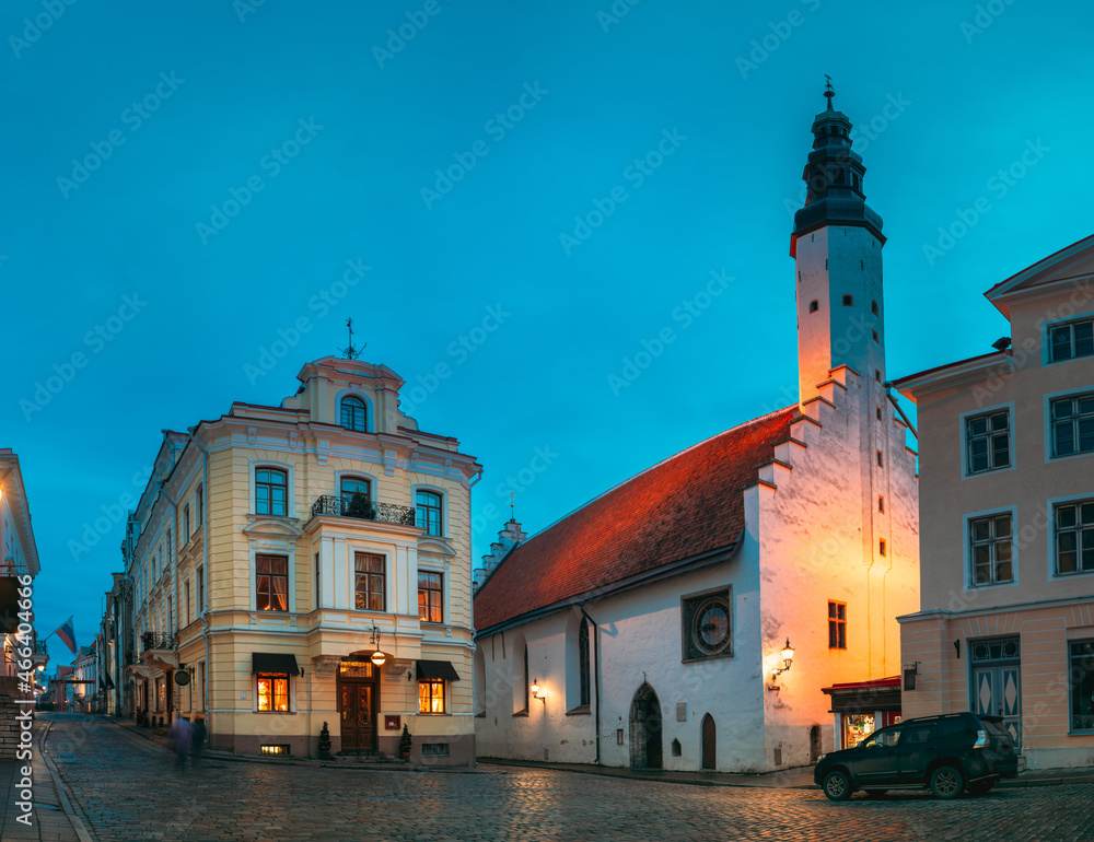 Tallinn, Estonia. Tower Of Church Of Holy Ghost Or Holy Spirit In Winter Evening Night.