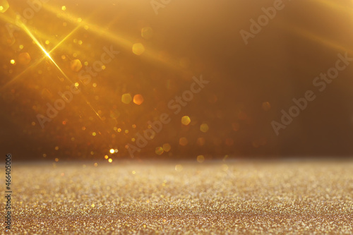 background of abstract gold and black glitter lights. defocused