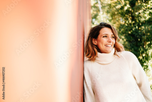 Relaxed young woman looking aside with a beaming smile