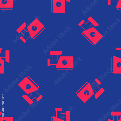 Red Kitchen meat grinder icon isolated seamless pattern on blue background. Vector