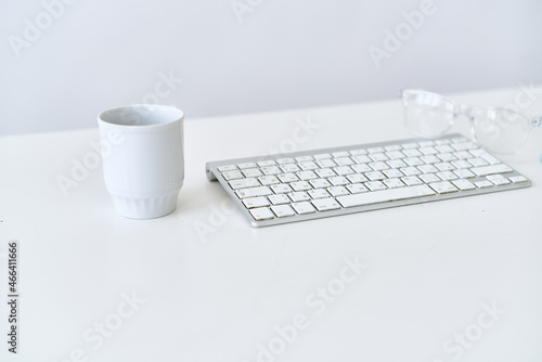 wireless keyboard on desktop cup documents office