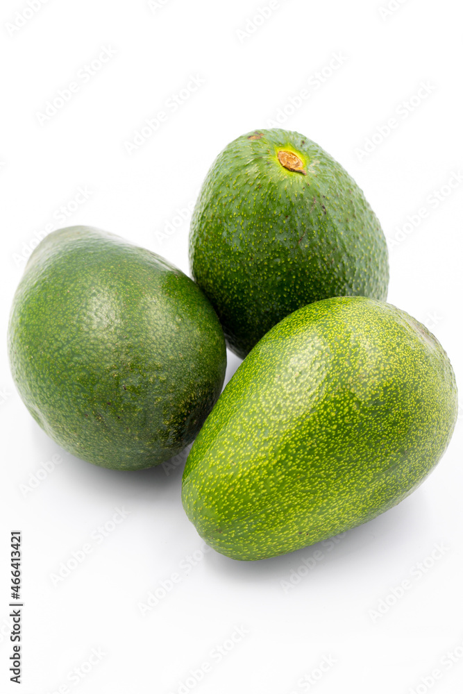 Avocado on a white background. Combined with the shade of ripe avocado. Story format close-up Avocado on a white background. Combined with the shade of ripe avocado. Story format close-up