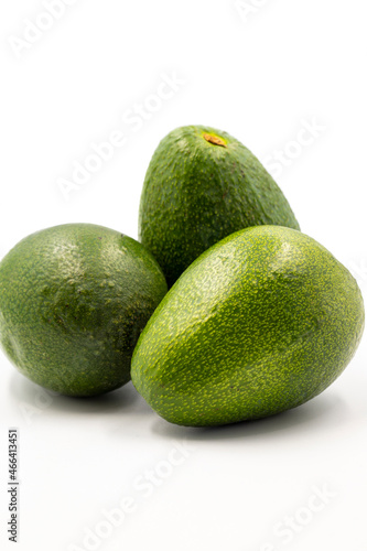 Avocado on a white background. Combined with the shade of ripe avocado. Story format close-up