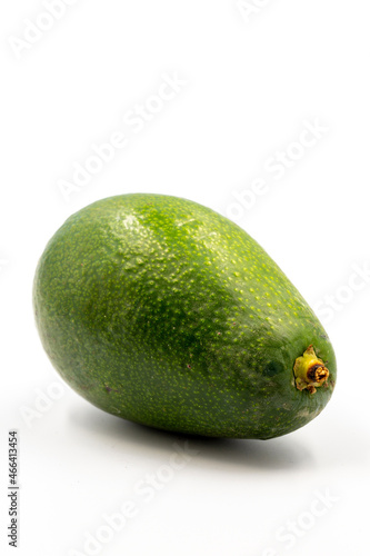 Avocado on a white background. Combined with the shade of ripe avocado. Story format close-up