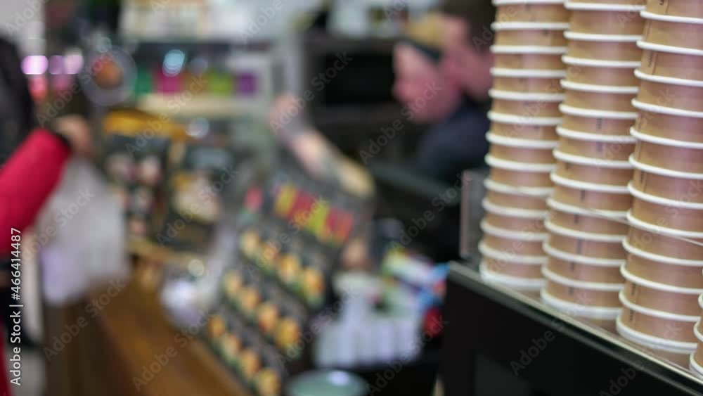 Blurred background of vendor giving a plastic bag with order to a customer. Blurred background of vendor giving a plastic bag with order to a customer.