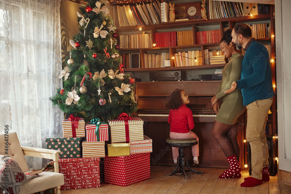 Mixed race family enjoying Christmastime at home Mixed race family enjoying Christmastime at home