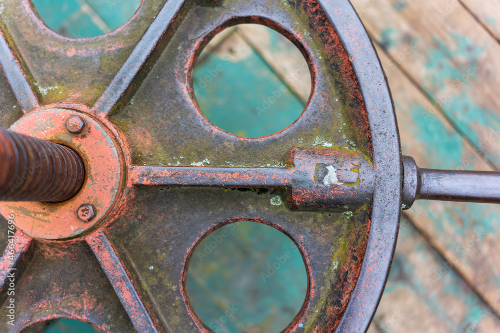 old metal round valve on wooden floor background old metal round valve on wooden floor background