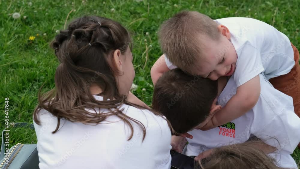 group of children of different ages are playing on the phone in the park. Selective focus group of children of different ages are playing on the phone in the park. Selective focus