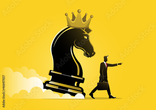 businessman pointing finger to direct chess knight
