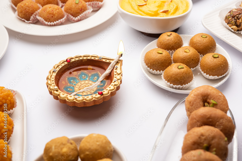 Group of Indian assorted sweets or mithai with diya