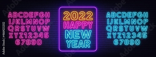 2022 Happy New Year neon lettering on brick wall background