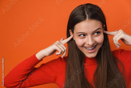 Wallpaper Mural Young white brunette woman laughing and plugging her ears Torontodigital.ca