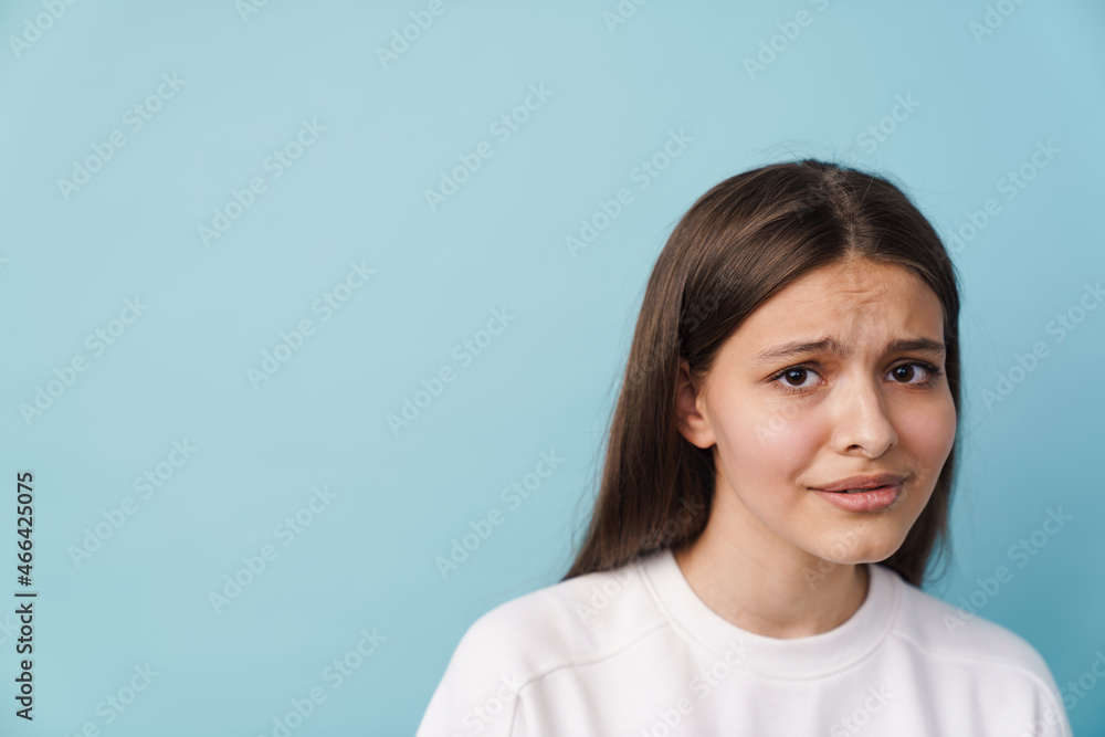 Young white brunette woman frowning and looking at camera Young white brunette woman frowning and looking at camera