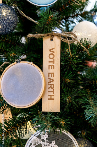 Zero waste eco-friendly christmas tree with wooden toy and text wote earth. Environmental concept photo