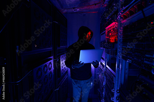 Hacker staring at data center network equipment
