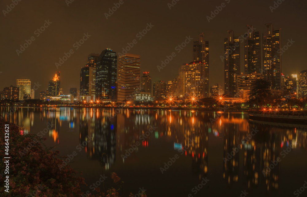 Fototapeta premium Night city at the park with commercial building