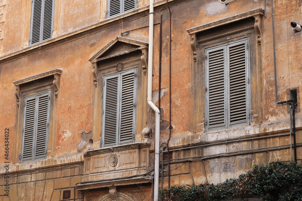 Traditional Brown Building Facade with Grey Shutters in Rome, Italy
