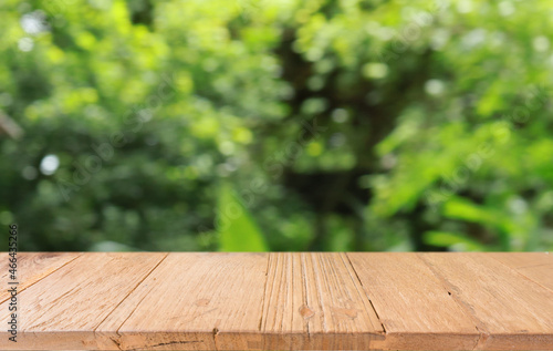 Empty wood table top and blur of out door garden background Empty wooden table space for text marketing promotion. blank wood table copy space