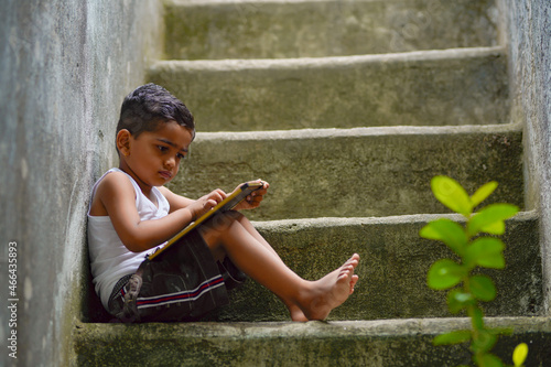 Cute indian little boy studying at home photo