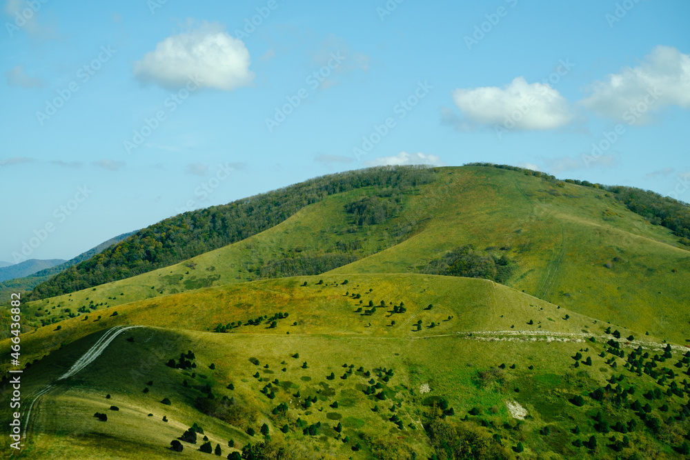 Landscape with green hill in summer and blue sky, no people.