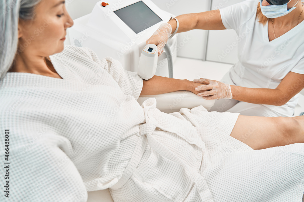 Close up of serious patient looking at her hand Close up of serious patient looking at her hand