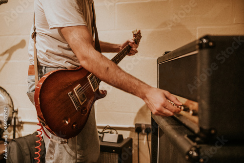 Bild auf Leinwand Musician setting guitar amp, studio recording session photo