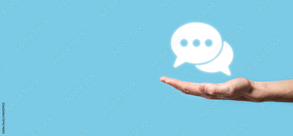 Businessman holding a message icon, bubble talk notification sign in his hands. Chat icon, sms icon, comments icon, speech bubbles Businessman holding a message icon, bubble talk notification sign in his hands. Chat icon, sms icon, comments icon, speech bubbles