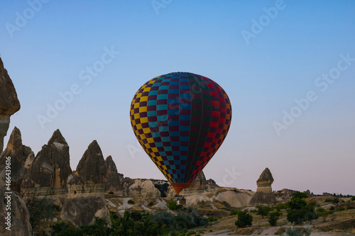 Hot air balloon taking off and fairy chimneys in Cappadocia