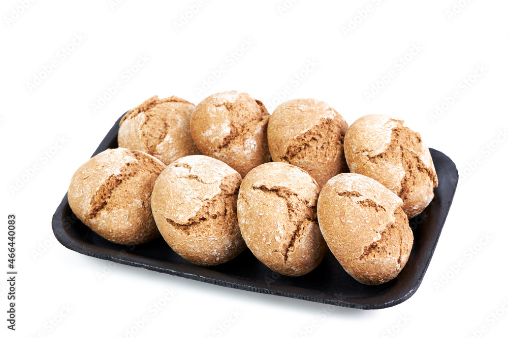 Six rye bread rolls isolated on black tray on white background