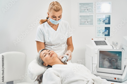 Positive delighted beauty master checking quality of skin
