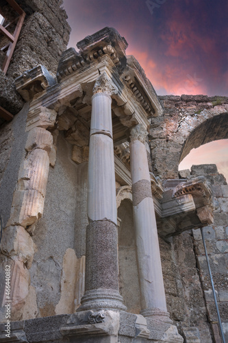 The Vespasianus Monument and the entrance gate of the ancient city of Side Selective Focus Gate. cloudy sunset Sky. Antalya. photo