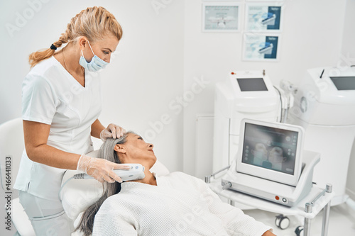 Profile photo of cosmetologist looking at screen