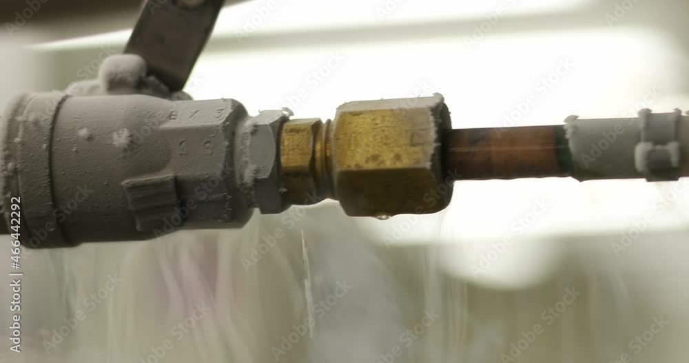 Liquid nitrogen tank with frozen transfer pipes, close up shot, real time, shallow depth of field Liquid nitrogen tank with frozen transfer pipes, close up shot, real time, shallow depth of field