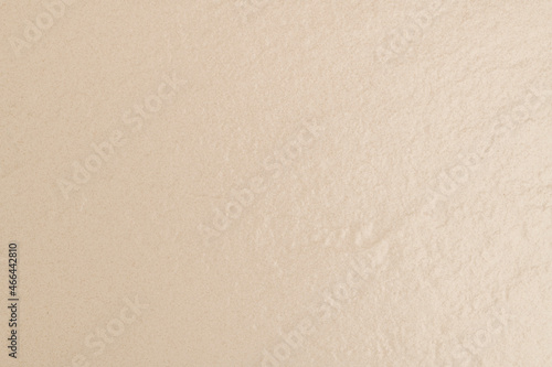 Beige textured concrete background with design space