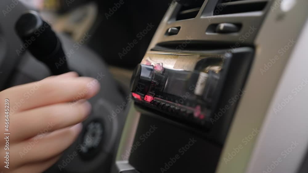 Close-up of a little boy turning the volume on a radio in the car, children playing in the car in the front seat. Close-up of a little boy turning the volume on a radio in the car, children playing in the car in the front seat.