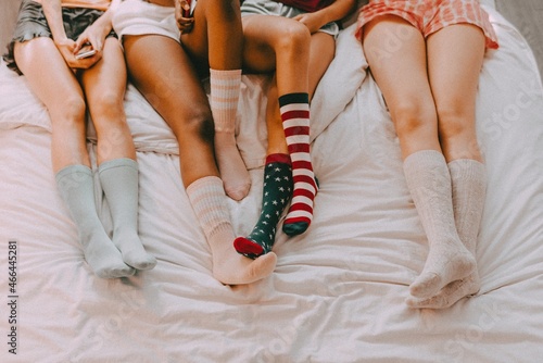 Teenage sleepover party aesthetic, girls wearing colorful socks photo