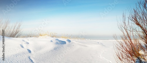 Frozen Baltic sea shore on a clear day, snow texture close-up. Blue sky. Picturesque winter scenery. Concept image. Seasons, nature, ecology, environment, climate change, global warming photo