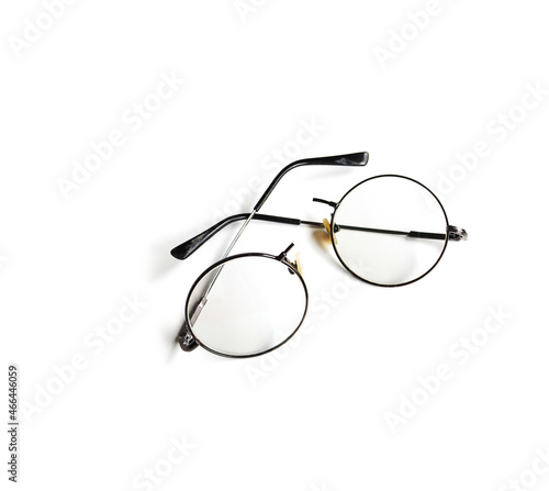 Black round frame eyeglasses have broken. It was broken in half into two pieces, placed on a white background.