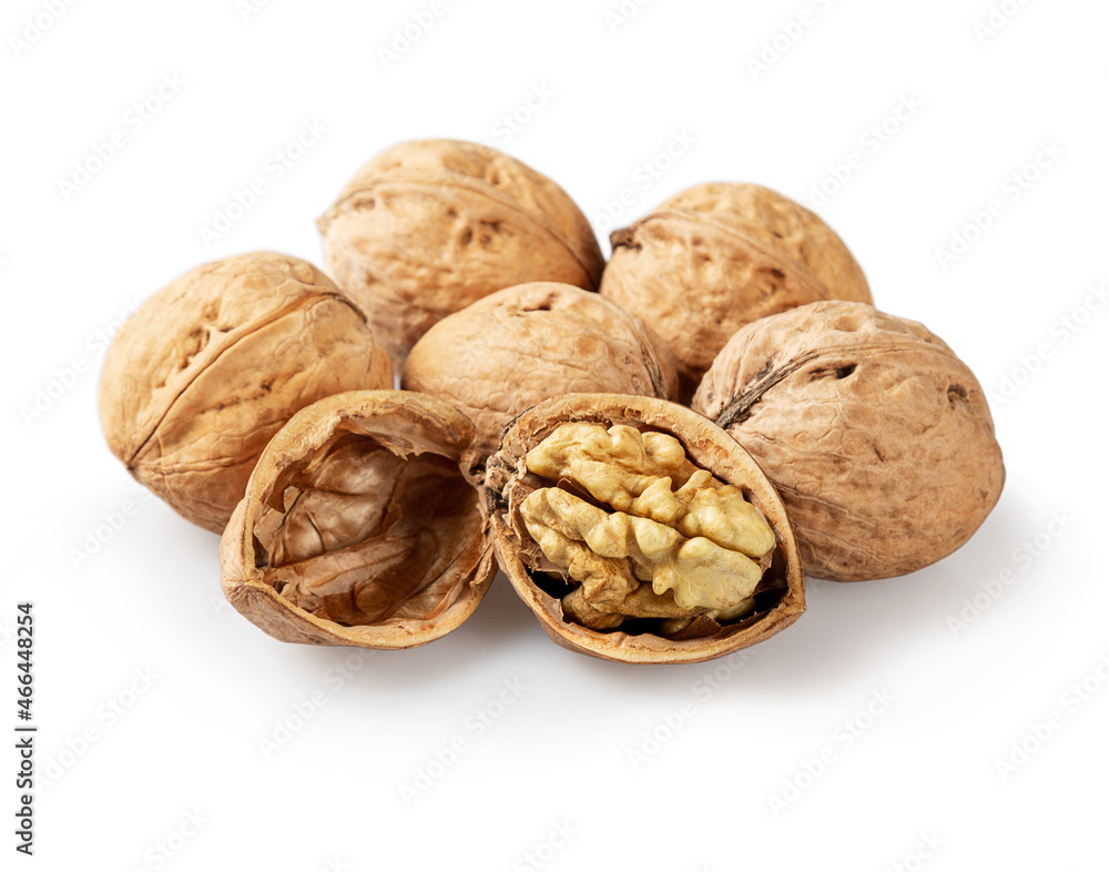 Whole and cracked walnuts on a white background Whole and cracked walnuts on a white background