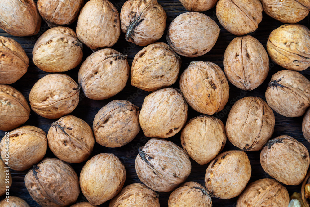 Walnuts on a brown wooden background. Walnuts on a brown wooden background.