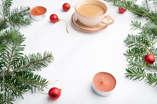 Christmas or New Year frame composition. Decorations, red balls, fir and spruce branches, on a white background. Side view, copy space.