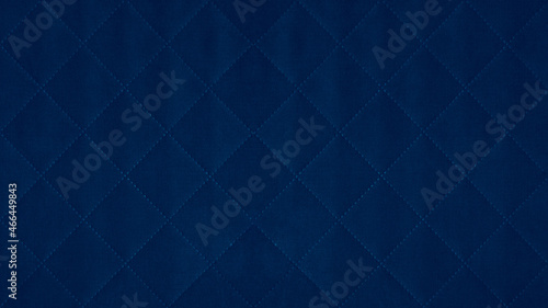 Dark blue colored seamless natural cotton linen textile fabric texture pattern  with diamond quilted  rhombic stiching.  stitched background