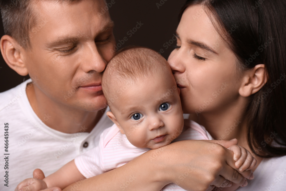 Happy family with little baby on dark background Happy family with little baby on dark background
