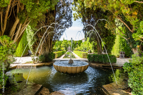 Fountain and trees in Generalife garden in Alhambra palace complex in Granada, Spain