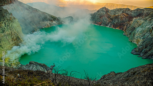 beautiful panoramic view of ijen crater at sunrise. sulfur fog billows over the turquoise lake into the air. kawah Ijen volcano, East Java, Indonesia.