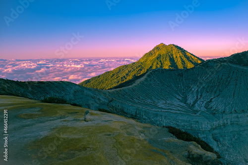 Beautiful panorama view of ijen crater at sunrise. puffs of sulfuric gas billowed over the turquoise lake into the clear  colorful sky. Ijen Crater  East Java  Indonesia.