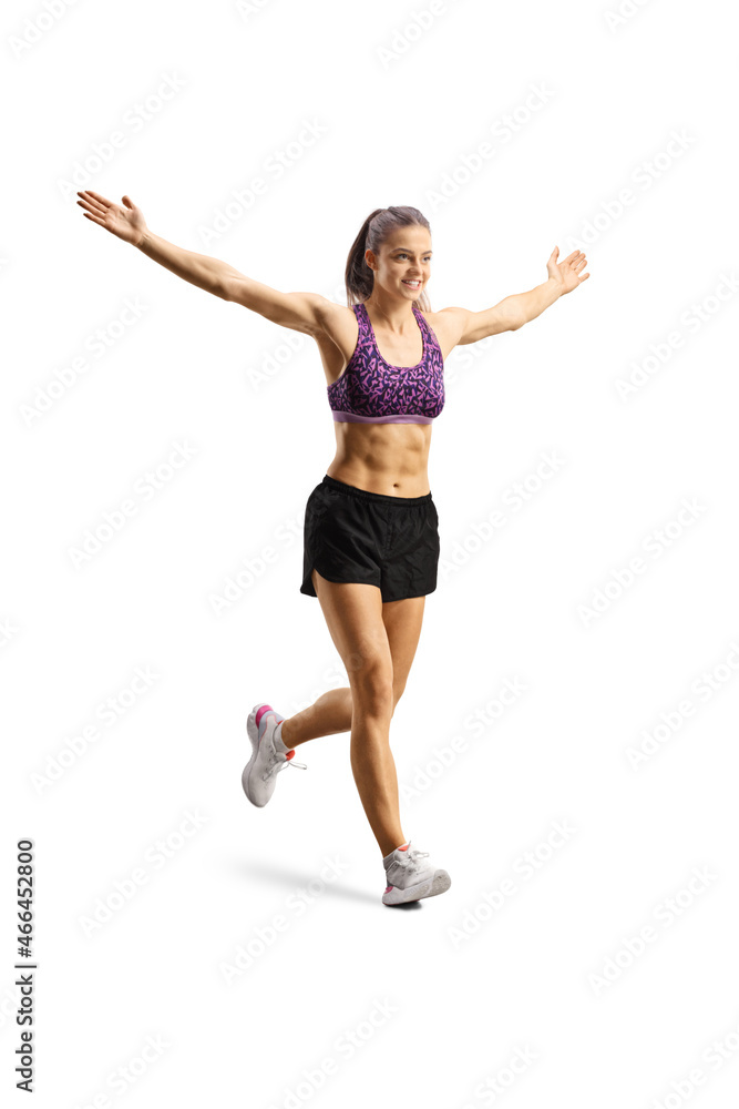 Full length shot of a fit young woman running and spreading arms wide open