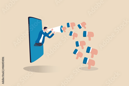 Internet hater, angry social media, dislike or negative feedback from remote work, cyber bullying concept, furious young man from mobile phone shouting on megaphone with negative thumb down symbols.